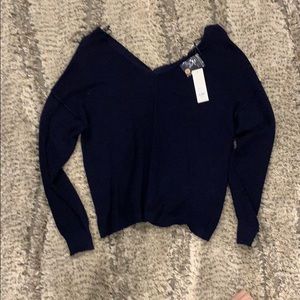 Navy blue sweater with buttons on the back